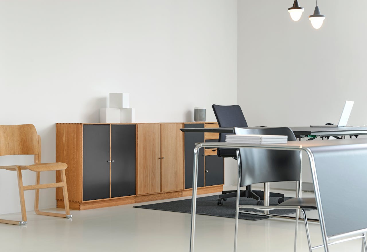 services-03 A clean and organized modern office space with stylish furniture and decor.